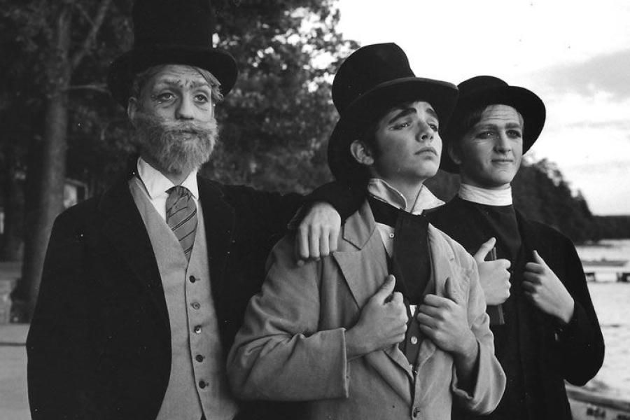 A black and white image of three students in costume