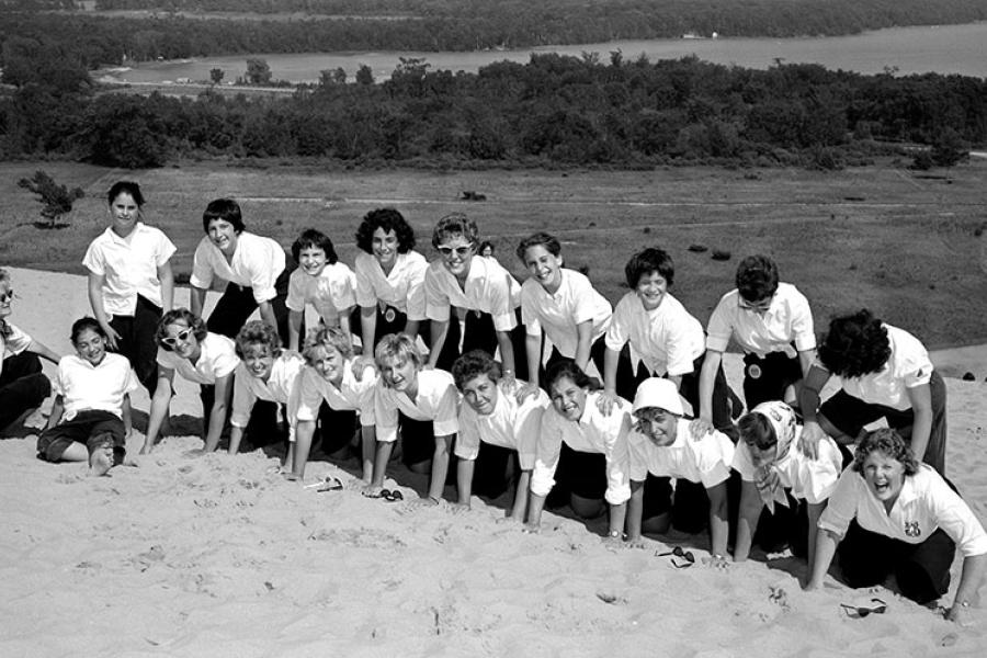 Interlochen students pose for a photo on a large sand dune